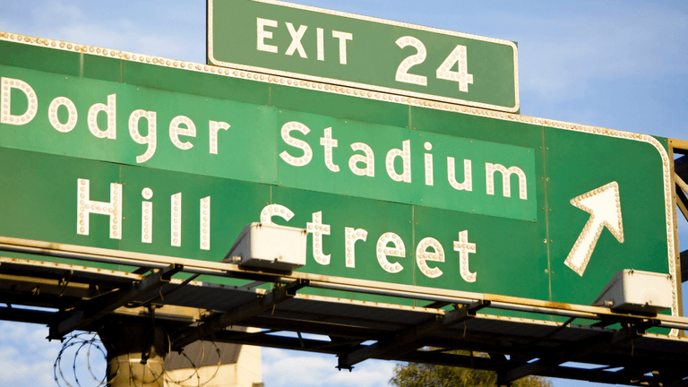 Green freeway sign directing traffic toward Dodger Stadium and Hill Street at Exit 24.